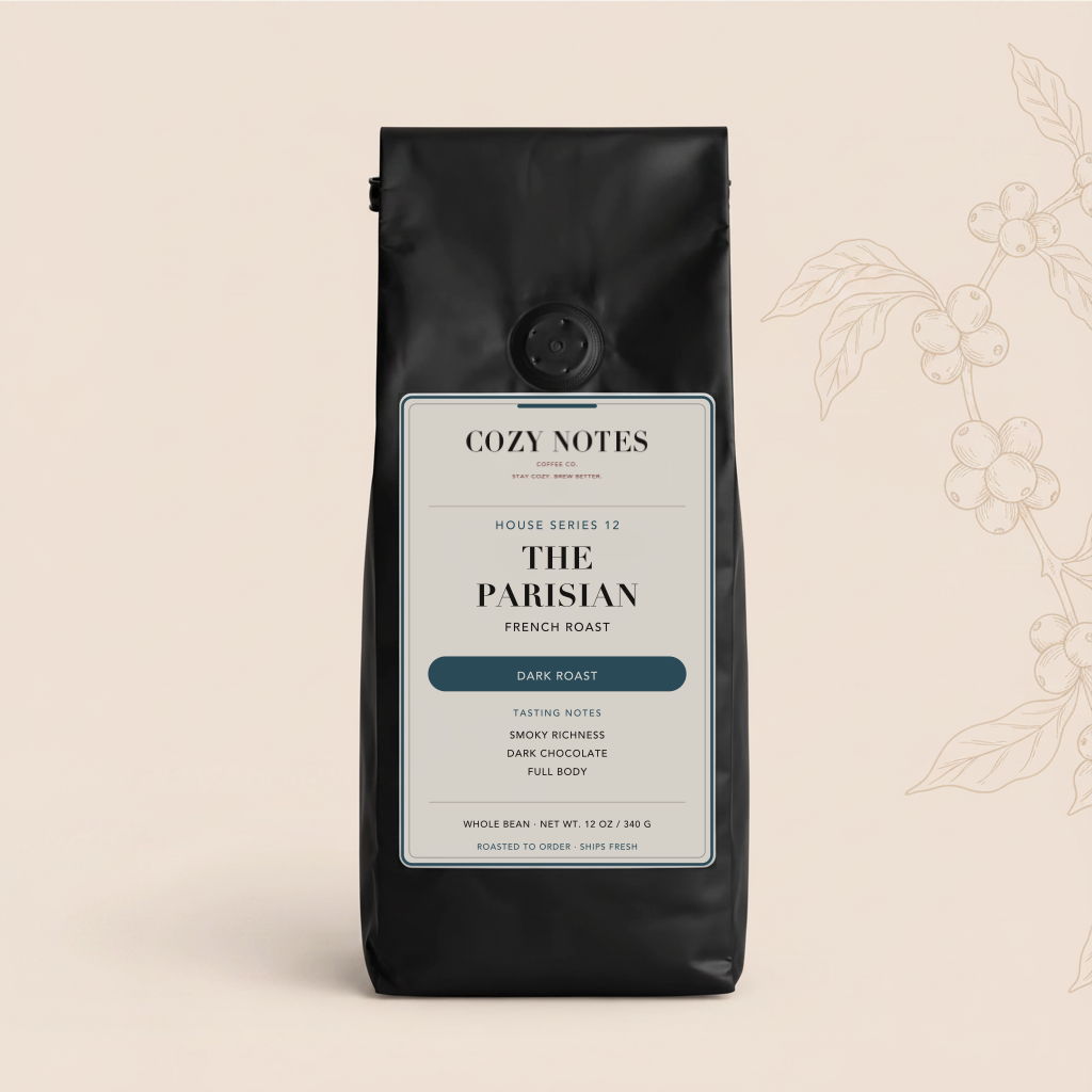A black bag of Cozy Notes House Series 12 'The Parisian' French Roast coffee beans, displayed on a light beige background with a subtle coffee bean branch illustration on the right.