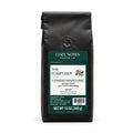 The Composer Colombian medium roast coffee, espresso grind, 12 oz black bag with the new Cozy Notes label, front view.