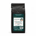 The Island Bali medium-dark roast coffee, whole bean, 12 oz — main view with Cozy Notes mountain label.