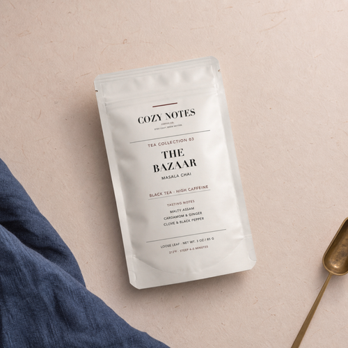 Overhead view of Cozy Notes The Bazaar masala chai pouch on rose clay and indigo