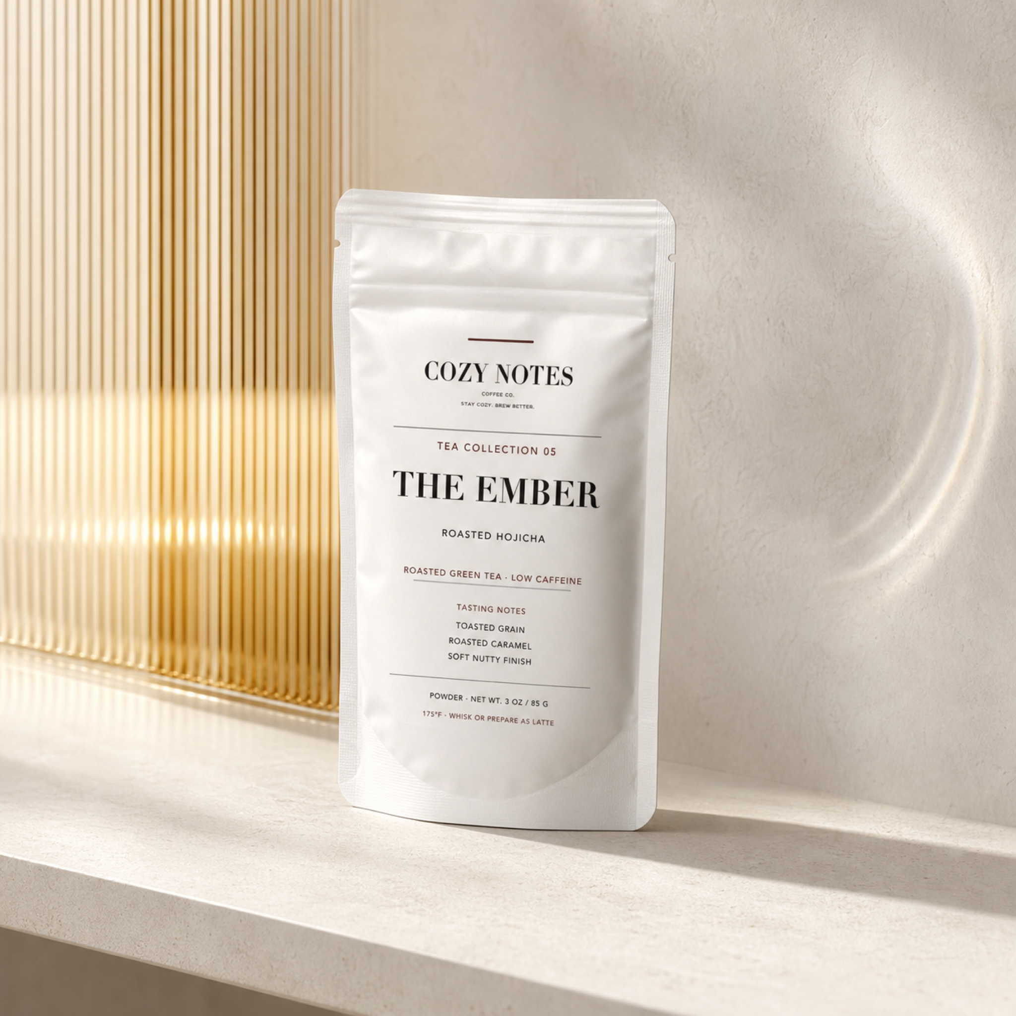 Cozy Notes The Ember roasted hojicha pouch in a refined smoked amber setting