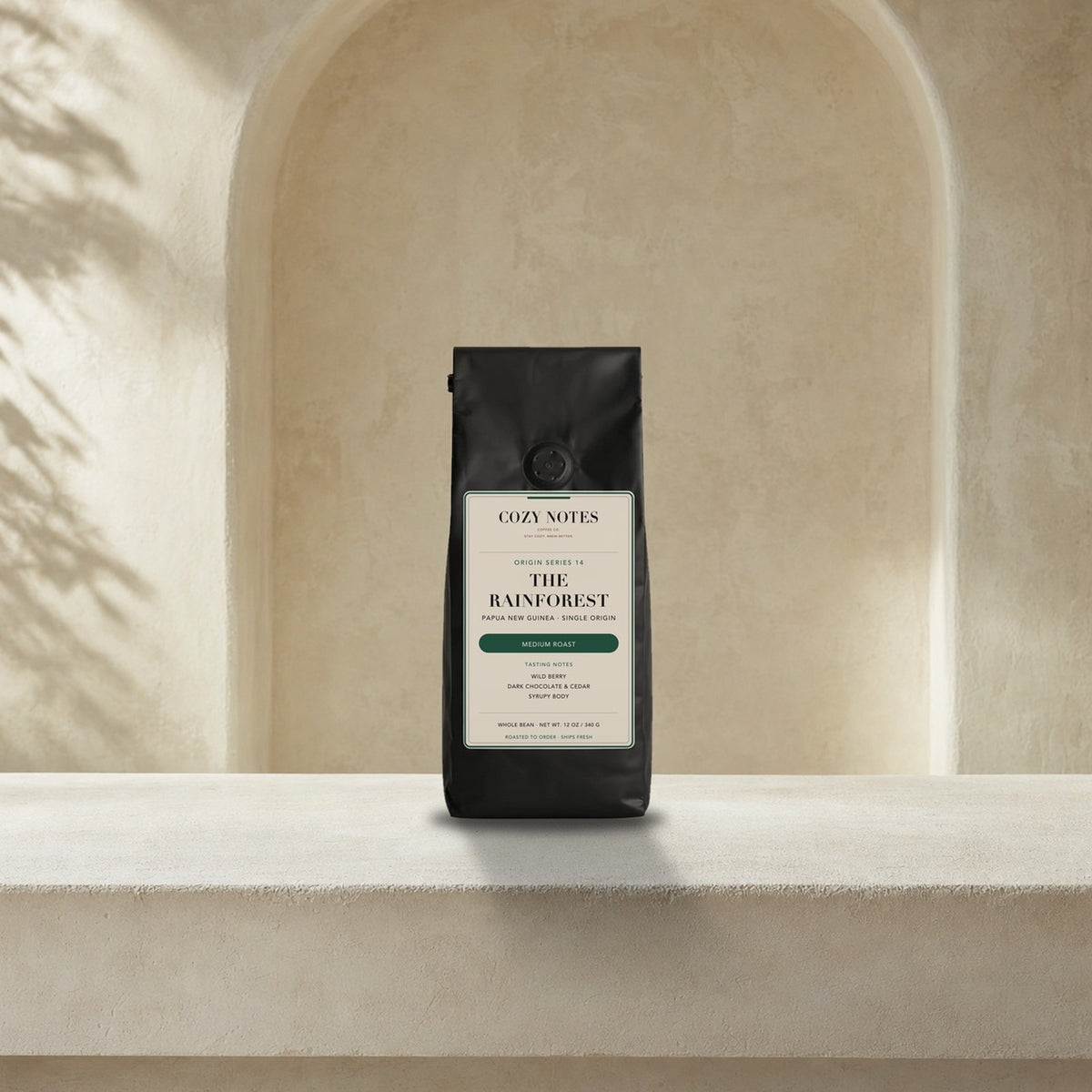 The Rainforest — Papua New Guinea Single Origin Coffee, Medium Roast — 12 oz Cozy Notes bag on a kitchen counter, roasted to order
