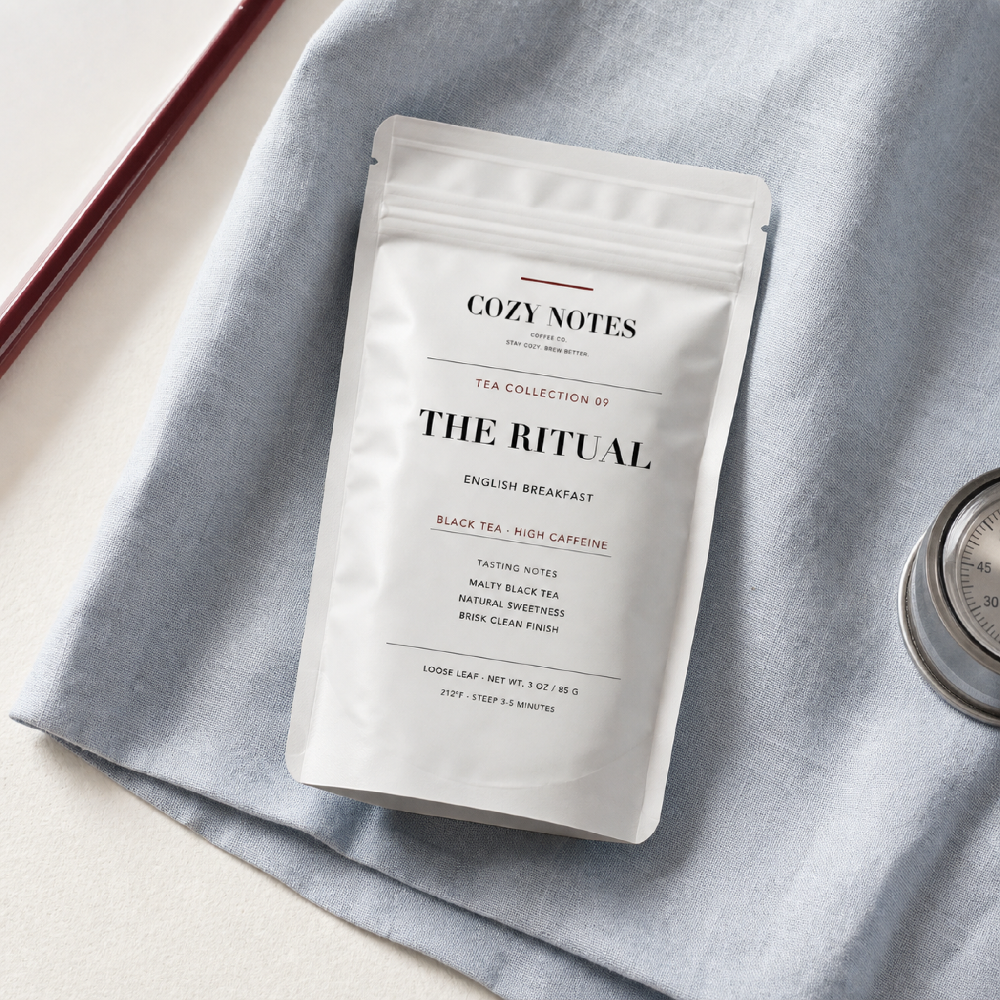 Overhead view of Cozy Notes The Ritual English breakfast tea pouch on powder blue linen