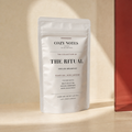 Cozy Notes The Ritual English breakfast tea pouch in a butter and oxblood editorial setting